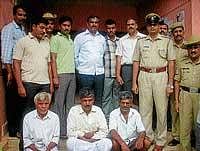 The accused Gowrimange Gowda, Shankaregowda and Kallepuri Rudresh arrested by the police in connection with the group clash between Congress and Janata Dal (Secular) activists at Bekkalale village, in Maddur on Wednesday. Circle Police Inspector Prashanth and staff are seen. dh photo