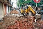 Operation: Footpath encroachments  being cleared by CMC authorities on V V road in Mandya on Wednesday.  dh photo