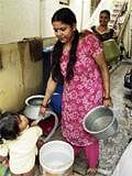 Women fetching water supplied from the private borewell  at Lakshmisagar Layout in Mahadevapura in Bangalore.  DH Photo
