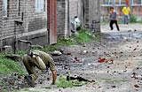 Hit-and-run: A paramilitary soldier falls after he was hit by a stone hurled by a protester in Srinagar on Thursday. PTI