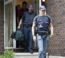 Police leave a home in the west end of Ottawa, Canada on Wednesday . AP