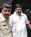 Hari Prasad, accused of tampering with an EVM, being taken to a court in Mumbai on Thursday. PTI