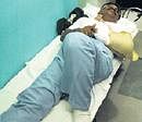 R Kannan, an injured passenger, being treated at a hospital in Mumbai on Friday night. PTI