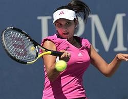 Sania Mirza of India returns a shot to Michelle Larcher De Brito of Portugal during the first round of the U.S. Open tennis tournament in New York. AP