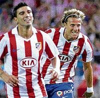 Atletico Madrids Diego Forlan (right) celebrates with Jose Antonio Reyes after scoring against Sporting Gijon. AP