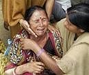 Women constables console the mother of kidnapped policeman Abhay Yadav as the Maoists' deadline on the condition of his release ends, in Patna on Thursday. PTI