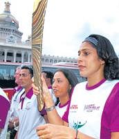 Former athletes Ashwini Nachappa and Reeth Abraham with the baton at the Vidhana Soudha. DH photo.
