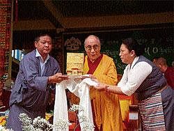 Tibetan spiritual Head Dalai Lama receiving a memento during the last day of the national general meet at Tibetan refuge camp at Bylakuppe near Kushalnagar on Thursday.