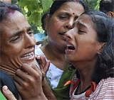 The wife (L) and daughter of police officer Abhay Yadav mourn after hearing news about the claim by Maoists that he has been killed, in Patna on Thursday. PTI