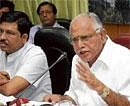 Chief Minister B S Yeddyurappa addressing the media at Krishna, his home office, in Bangalore on Friday. Minister Murugesh Nirani is also seen. DH photo