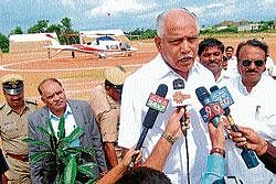Assertion: Chief Minister B S Yeddyurappa talking to media persons at helipad in Arsikere on Tuesday.  dh photo