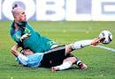 Argentina's Carlos Tevez (bottom) scores his team's third goal past Spain's goalkeeper Pepe Reina in Buenos Aires on Tuesday. AP