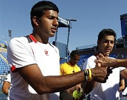 Rohan Bopanna of India, left, and partner Aisam-Ul-Haq Qureshi of Pakistan sign autographs after winning their semifinals doubles match during the U.S. Open tennis tournament in New York, Wednesday, Sept. 8, 2010. AP