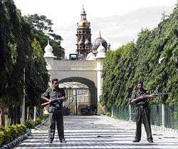 Safety first: Gun totting private security guards between Varaha and Karikal Thotti Gate of Amba Vilas Palace in Mysore. dh photo