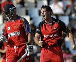South Australia's bowler Daniel Christian, right, reacts after dismissing Highveld Lions' captain Alviro Petersen, left, for 56 runs during the Champions League Twenty20 cricket match at the Supersport Park in Pretoria, South Africa on Sunday. (AP)