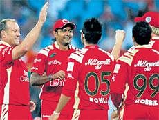 Well done, mate!: Jacques Kallis (left) is congratulated by his Royal Challengers team-mates after getting rid of Ramnaresh Sarwan on Sunday. AP