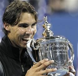 Rafael Nadal of Spain bites his trophy after beating Novak Djokovic of Serbia to win the men's championship match at the U.S. Open tennis tournament in New York, Monday. AP Photo