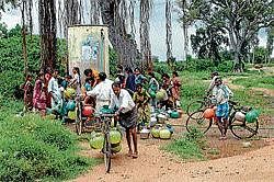 Residents of Kaggala village of Chamarajanagar district collecting drinking water from mini water supply tank. dh photo