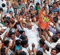 BJP supporters celebrating victory of Dr Y C Vishwanath by lifting him up, for being elected as MLA from Kadur constituency.  DH Photo