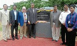 Principal secretary, IT and BT, Ashok Kumar Manoli (third from right), Police  Commissioner Sunil Agarwal, CEO, MD, SPI, Sid Mookerji, Chairman, John Cook, VP, Financial Services, Jeff, Deakin, VP, Global Head, HR, Solomon Suresh and VP, Girish Karunakaran are seen after unveiling foundation plaque at SPI in Mysore on Thursday. dh photo