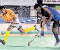 Water Hazard :Amit Gowda of Mumbai (right) tries to stop a cross from Nikkin Thimmaiah of Karnataka in the under-20 hockey Test series on Thursday. DH photo
