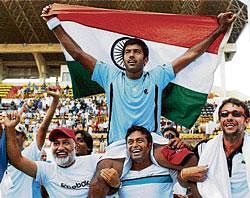 In elite club: Tennis players Rohan Bopanna, Somdev Devvarman and Leander Paes celebrate their victory after  beating Brazil 3-2 during the Davis Cup World group play-off at the SDAT Stadium in Chennai on Sunday. PTI