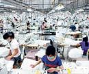 Employees work on the production floor at the Textile Alliance Apparel factory in the Qingxi township, China.  NYT