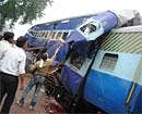 Labourers weld open a mangled train compartment after a crash in Shivpuri district on Monday. AFP