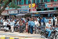 The employees of a call centre anxiously waiting on the road following a hoax bomb call, in Mysore on Monday. dh photo
