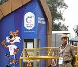 Security personnel stands guard near the entrance to the Commonwealth Games village in New Delhi on Tuesday. AP