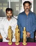 Francis and Shyam with the seized idols.