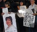 Death penalty protestors hold signs as they protest the execution of Teresa Lewis outside the Greensville Correctional Center in Jarratt, Virginia. on Thursday. AP