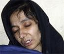 In this July 17, 2008 file photo, accused al-Qaida associate Aafia Siddiqui is seen in the custody of Counter Terrorism Department of Ghazni province in Ghazni City, Afghanistan. AP