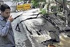 ground reality: Adding to the terrible mess surrounding the Commonwealth Games, this road caved in at Vikas Marg in New Delhi on Friday. PTI