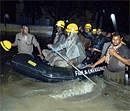 Firemen use a raft to rescue workers at the newly-inaugurated TTMC on K H Road.