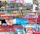 EERIE CALM: A trader sleeps in his shop in Ayodhya on Saturday as the temple town wore a deserted look ahead of the court verdict on the Ramjanmabhoomi-Babri Masjid title suits. PTI