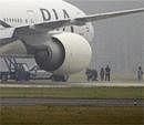 Anti-terror  policemen secure one of the passengers as a Pakistan International Airlines Boeing 777 is evacuated at Stockholm Arlanda International airport on Saturday. AP