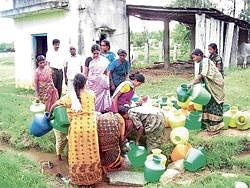 Saviour: Women of Muskam village in Kolar Gold Fields collecting drinking water.  (Inset) R Devaraj. DH Photo