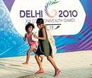 Mother indias other india: Children looking for scrap run past a Commonwealth Games hoarding in New Delhi on Saturday. AFP