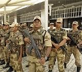 Paramilitary commandos stand in a group for a security briefing at the Indira Gandhi International Stadium ahead of the Commonwealth Games,