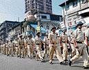 Policemen march as part of security measures on the eve the crucial Supreme Courts hearing on Ayodhya title suits, at Bhendi Bazaar, in Mumbai on Monday. PTI