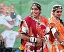 School girls dressed in traditional Indian attire prepare to participate in a performance at the Commonwealth Games village in New Delhi on Tuesday. AP