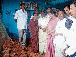 Opposition Leader in the Legislative Council Motamma visiting the places where houses collapsed due to heavy rains at Ambedkarnagar near Kadur. MLC Gayathri Shanthegowda, District Congress President M L Murthy, Kadur unit President M H Chandrappa, M Rajappa and others look on.