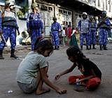 Children play as Rapid Action Force soldiers patrol a street ahead of the Ayodhya verdict, in Ahmadabad, India, Wednesday, Sept. 29, 2010. The Allahabad High Court is scheduled to rule Thursday in the 60-year-old case on whether the site in the town of Ayodhya should be given to the Hindu community to build a temple to the god Rama or returned to the Muslim community to rebuild the 16th-century Babri Mosque that was razed by Hindu hard-liners in 1992. AP