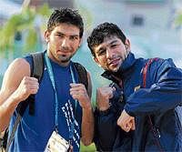 Two to tango:  Boxers Dilbag (left) and Manoj strike a telling pose at the Games Village. DH photo