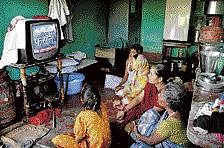 A family watches television as they awaits news on the  Ayodhya verdict on Thursday. AP