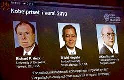 Portraits on overhead screen (from left) show American Richard Heck and Japanese researchers Ei-ichi Negishi and Akira Suzuki who won the 2010 Nobel Prize in chemistry on Wednesday. AP