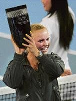 Denmarks Caroline Wozniacki holds aloft the World No 1 trophy in Beijing on Thursday. AFP