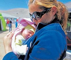 Happiness round the corner: Elizabeth Segovia holds her daughter Esperanza Ticona, the first baby of trapped miner Ariel Ticona, at a camp outside the San Jose mine near Copiapo, Chile, on Saturday. AP