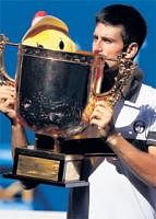 Classy show: Novak Djokovic kisses the China Open trophy after defeating David Ferrer in Beijing on Monday. AFP